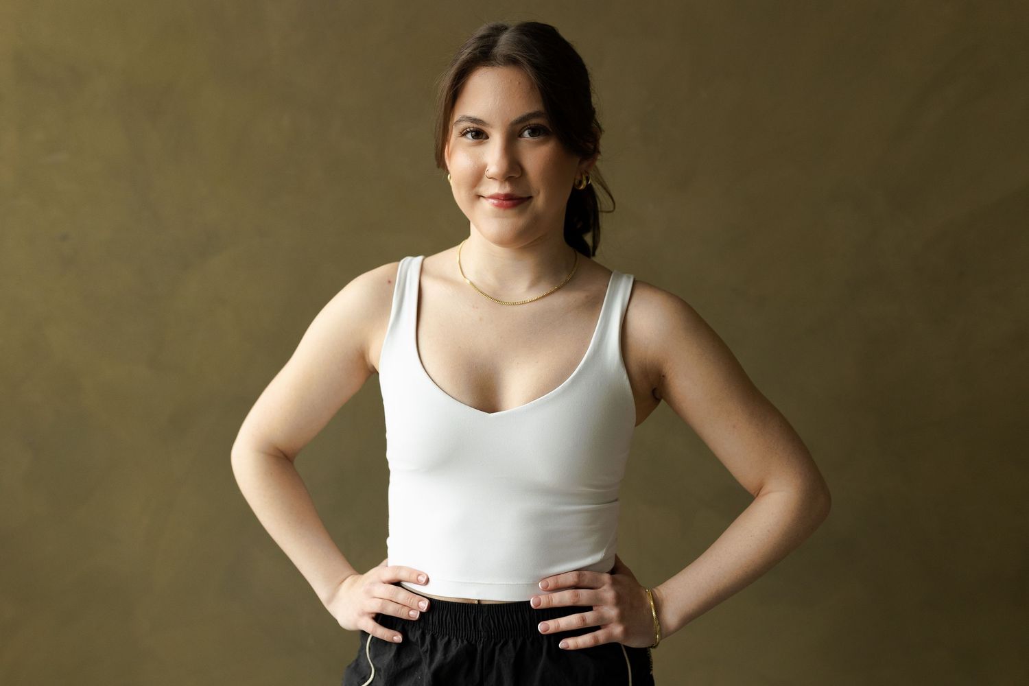 Series showing person in white tank top posing against brown studio backdrop.