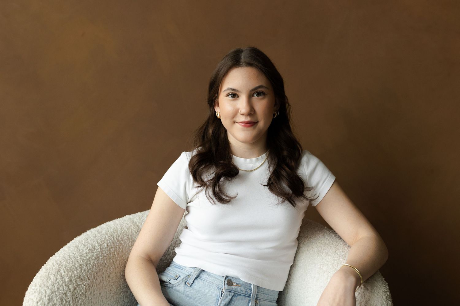 Casual portrait series against textured brown backdrop.