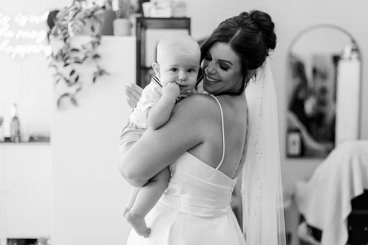 Black and white photos capturing intimate moments during wedding preparations.