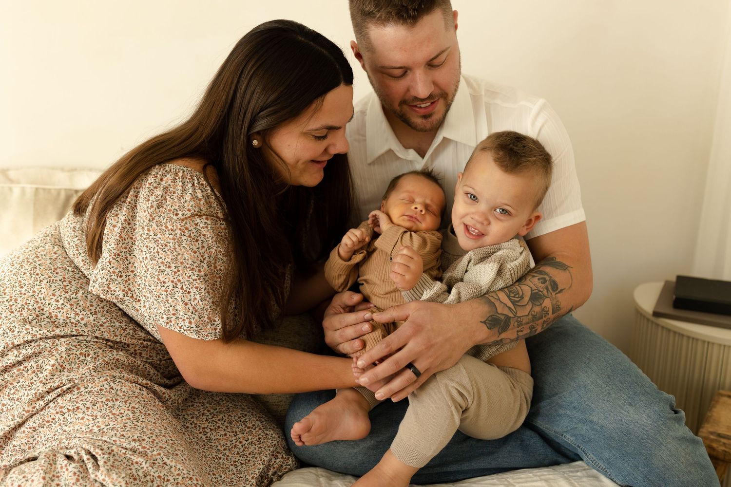 Parents share tender moments with their baby in a series of candid indoor photographs.