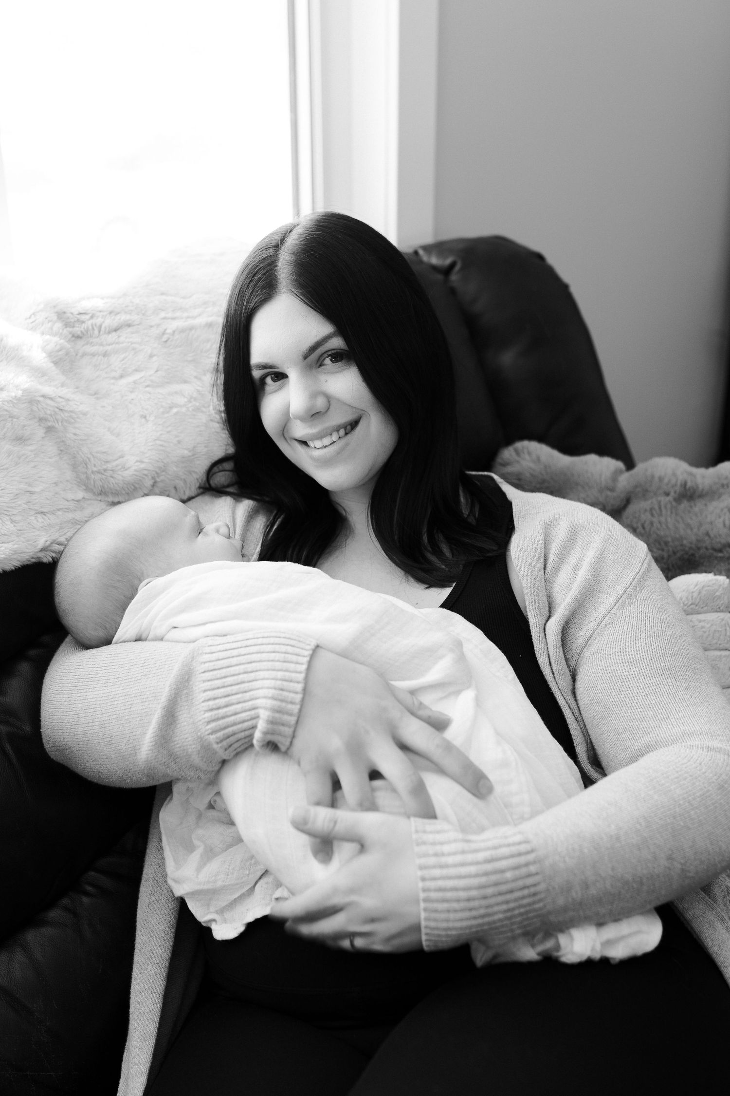 Tender moments captured in black and white as a family bonds with their newborn.