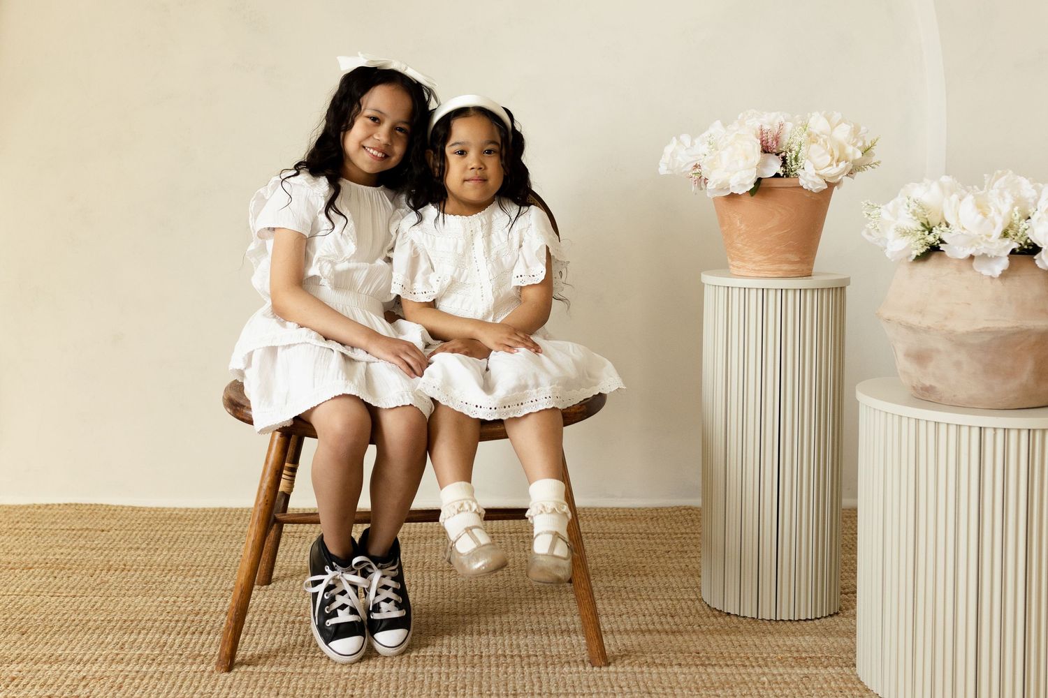 Family portrait series with white decor elements and natural lighting.