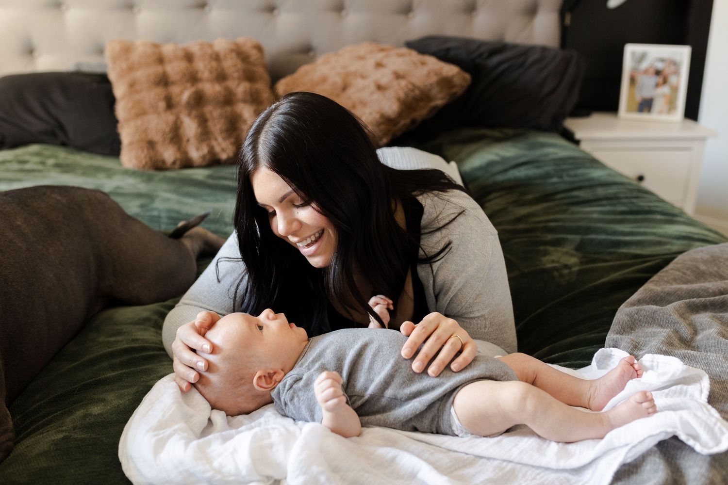 Candid moments of a family bonding together on a tufted bed.