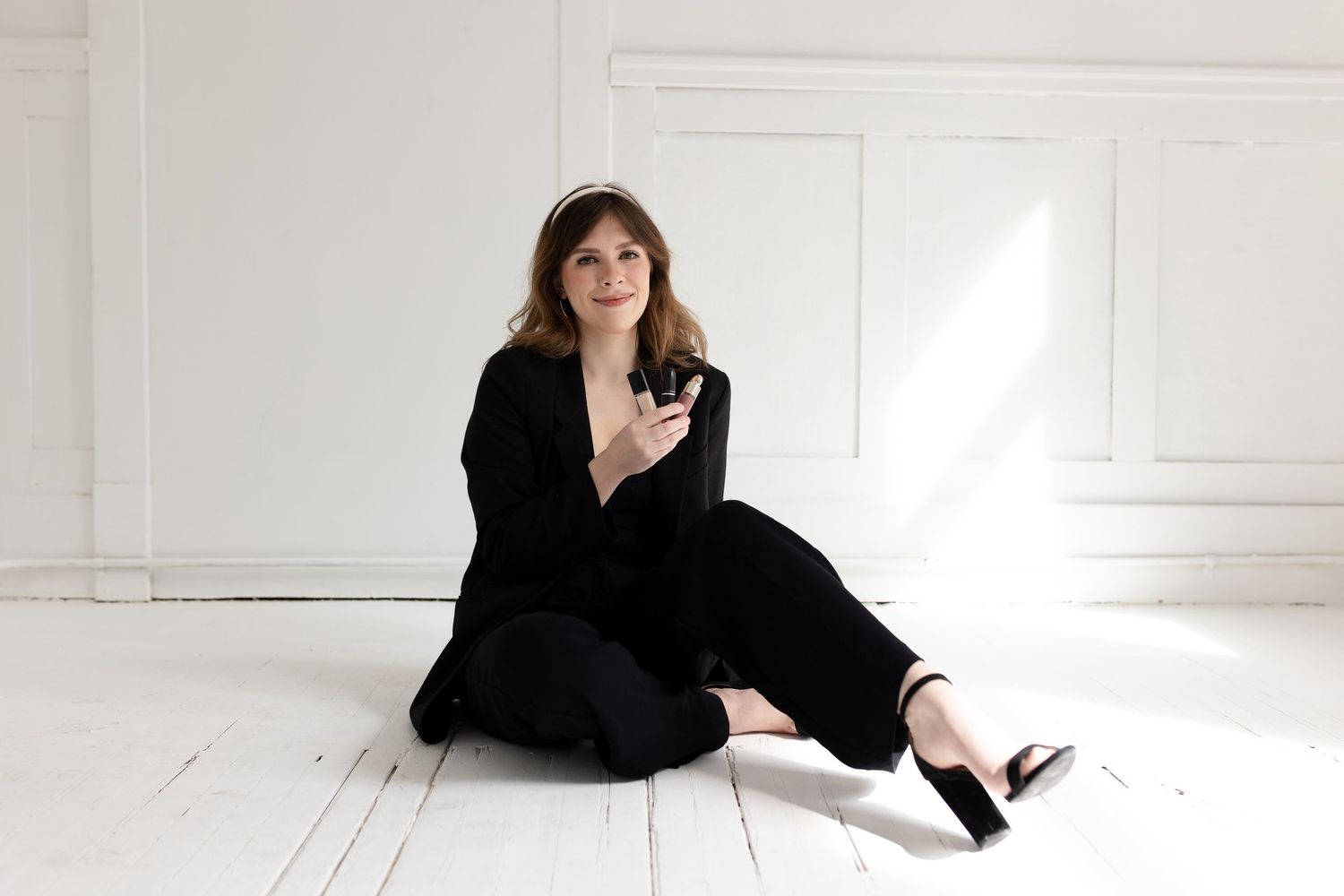 Black and white photo series showing relaxed poses in a bright white studio setting.
