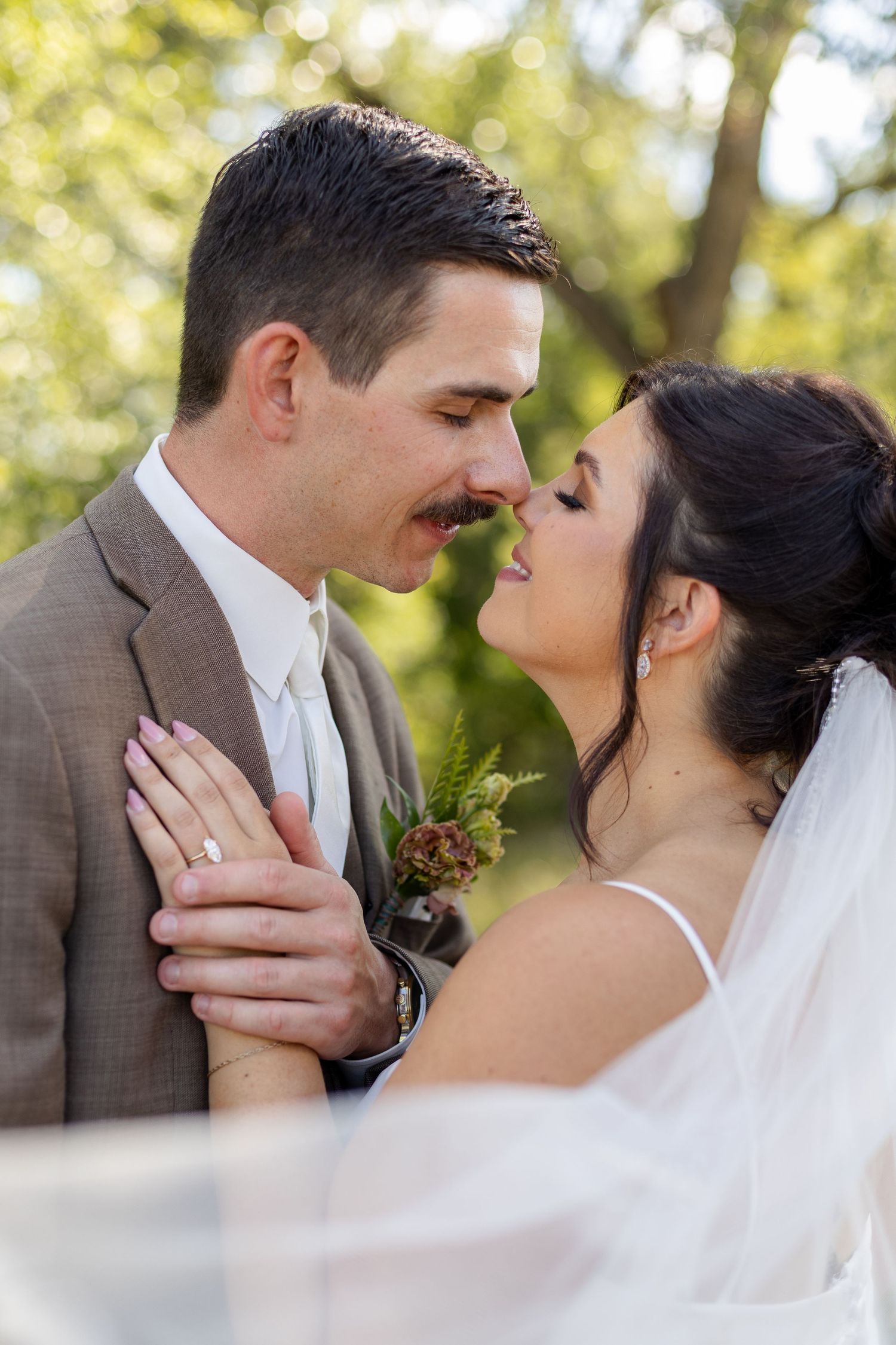 Intimate close-up sequence of a wedding couple sharing romantic moments in natural lighting.