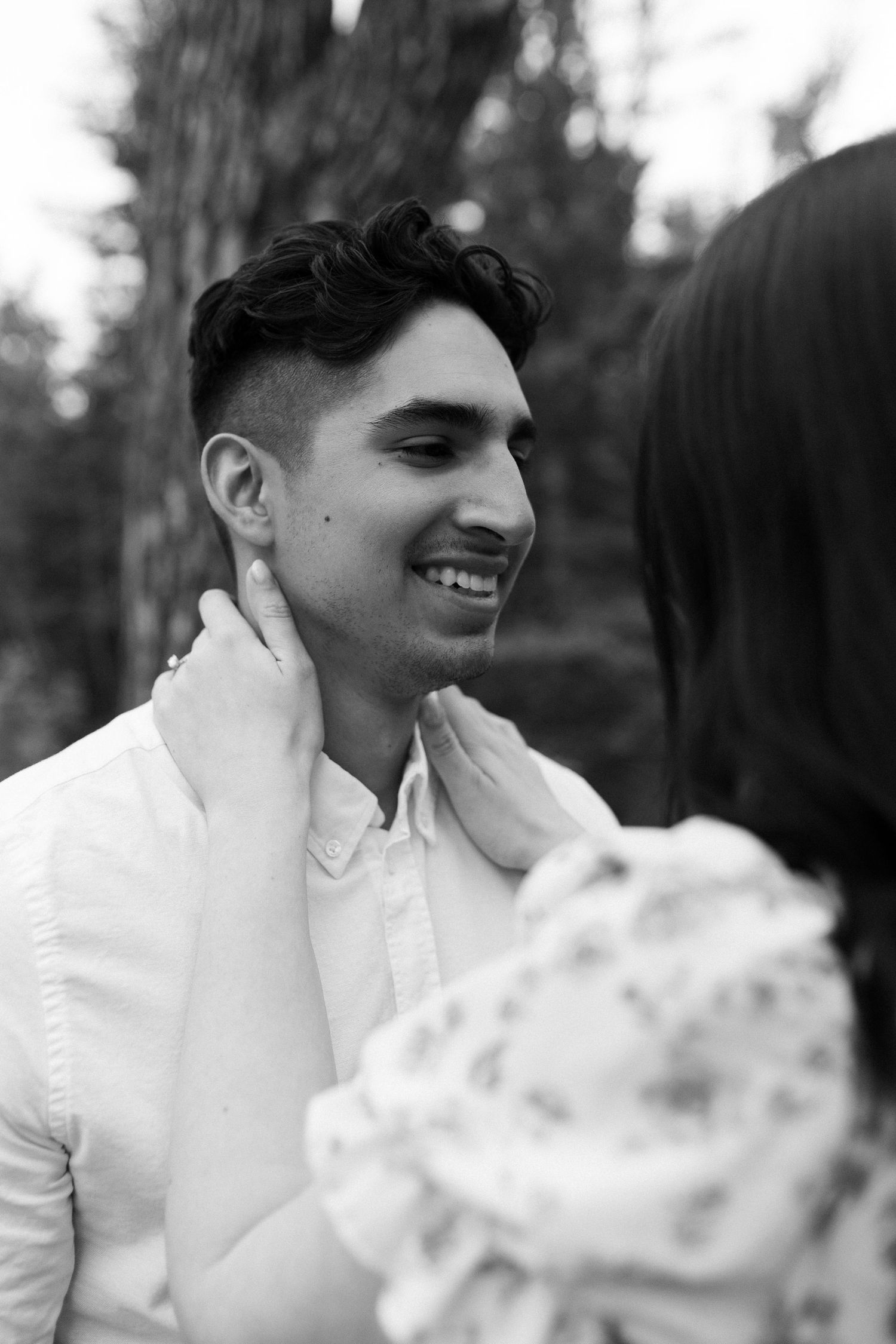 Black and white portrait showing joyful expressions in natural lighting.