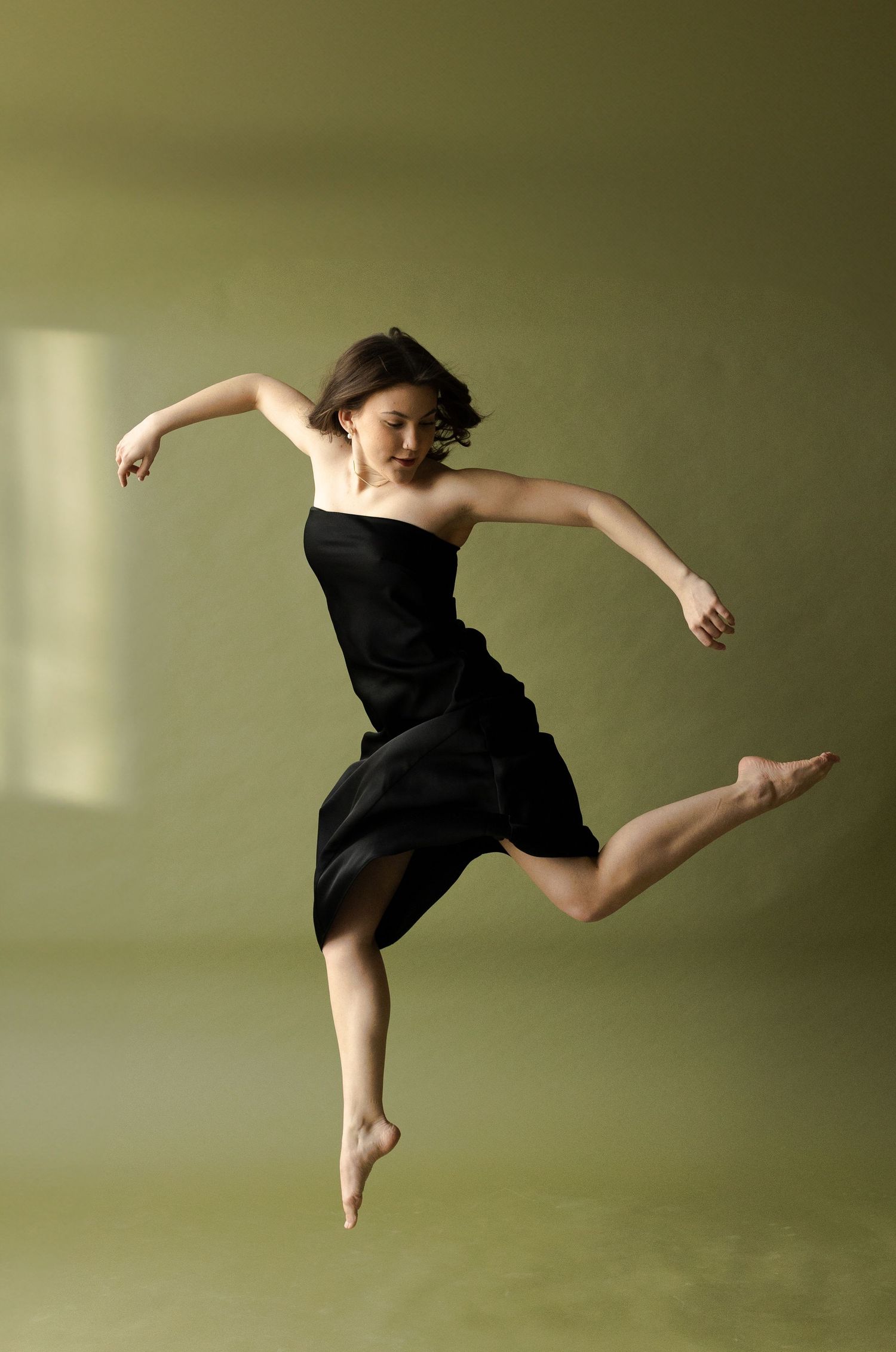 Dynamic dance movements captured in silhouette against an olive green background.