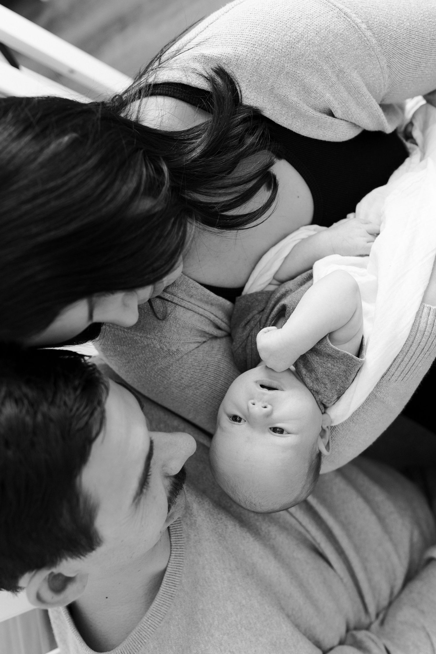 Black and white intimate photos of a family sharing loving moments together.
