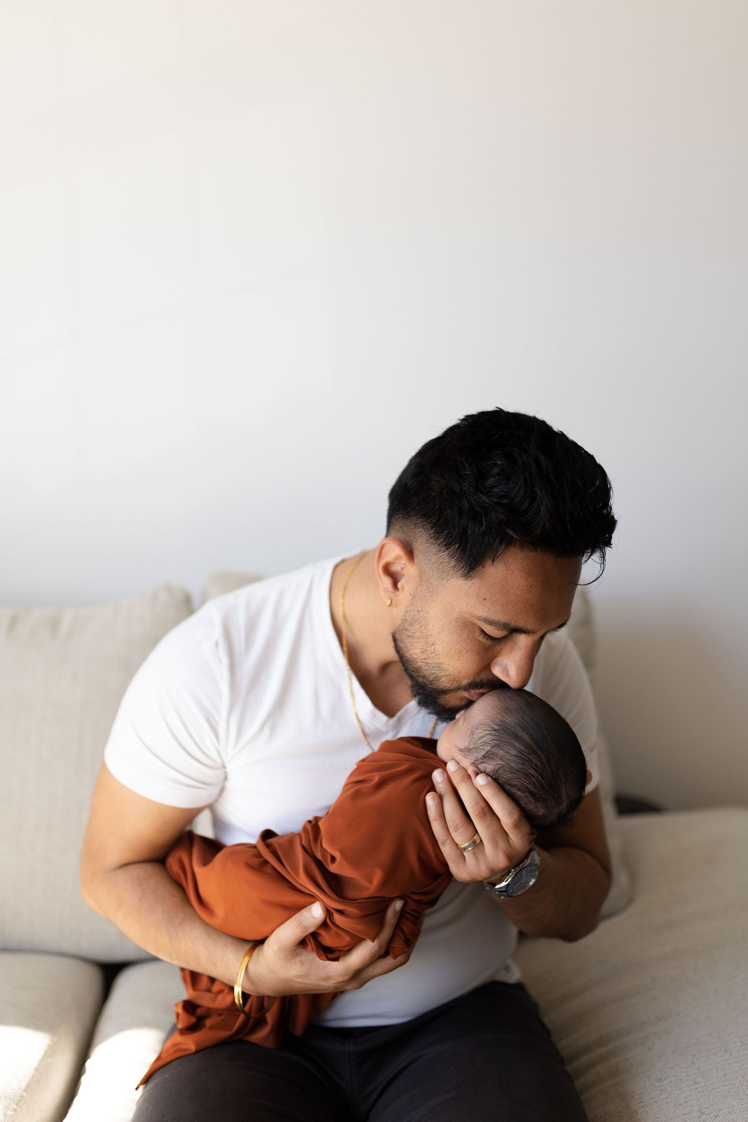 A series of intimate moments showing parent and child bonding in warm lighting.
