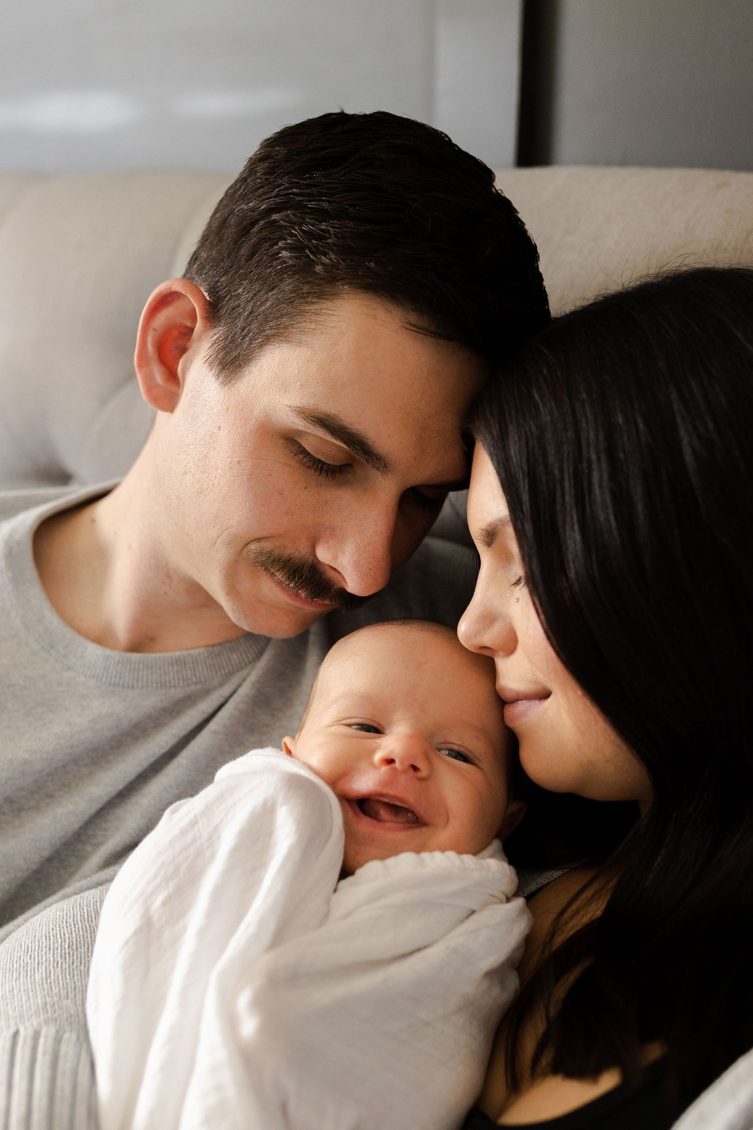 Intimate family moment captured in soft, monochromatic tones.