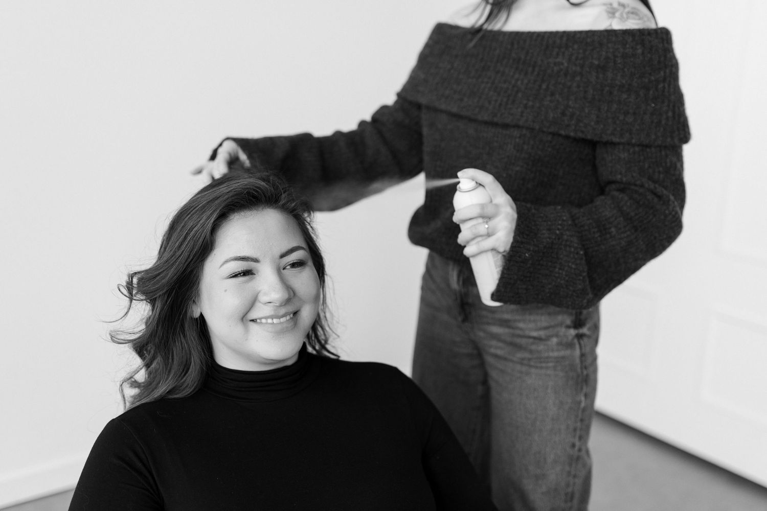 A black and white photo collage shows four candid portrait shots of a person smiling and posing naturally.