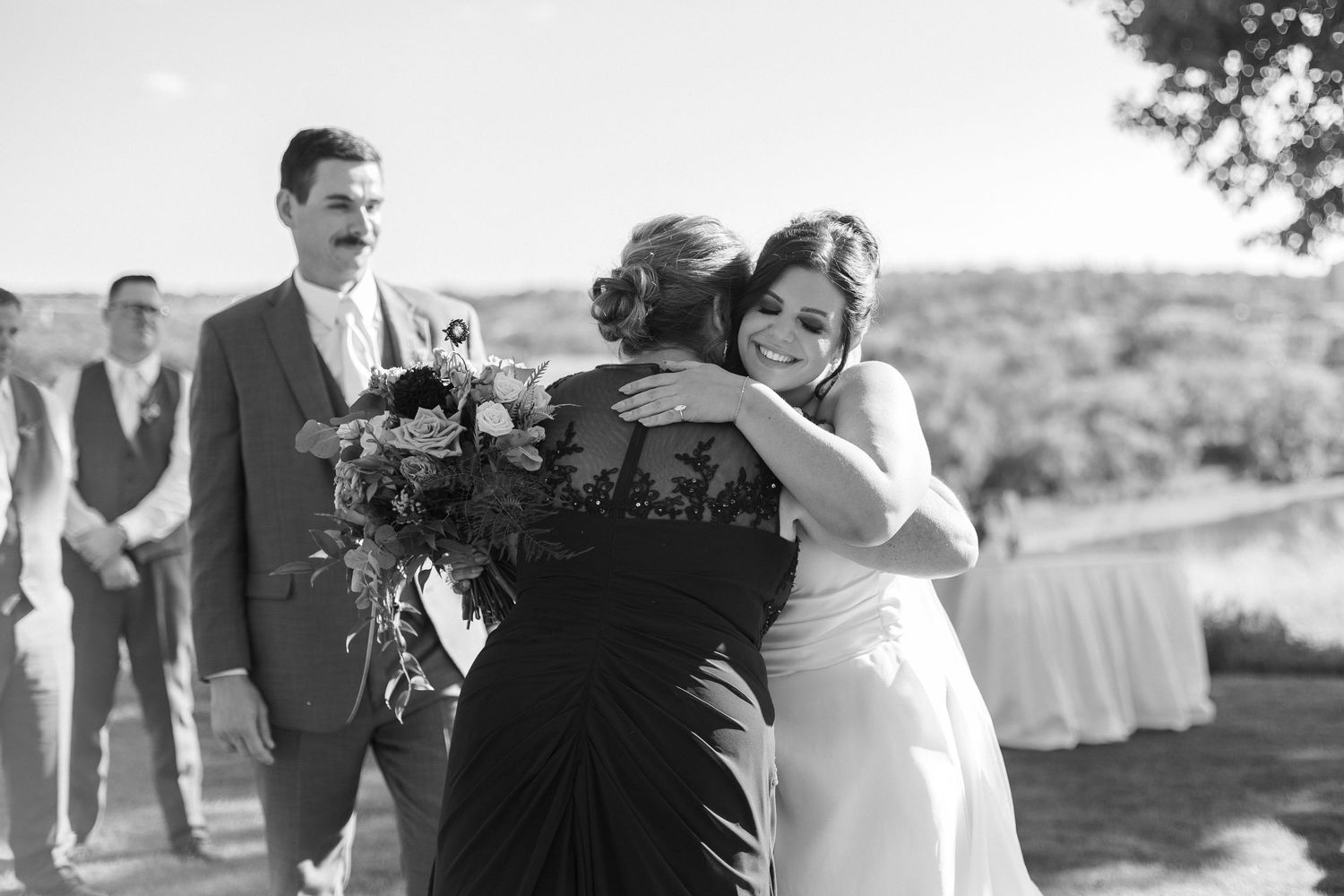 Candid wedding celebration moments captured in outdoor setting.