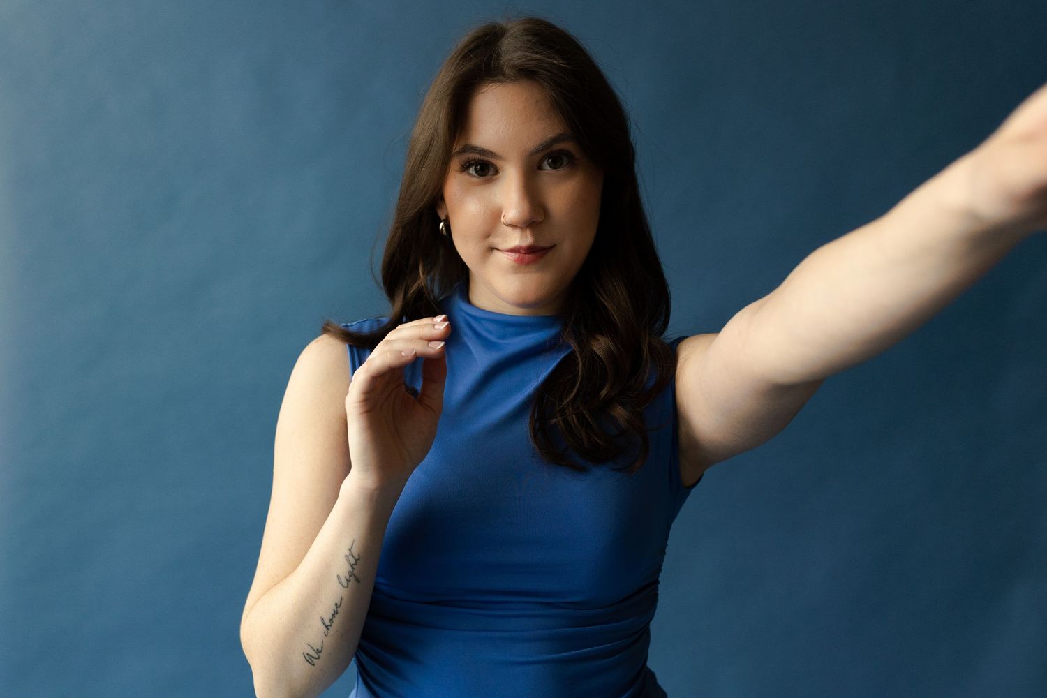 A collection of dance poses in a blue sleeveless top against a dark background.