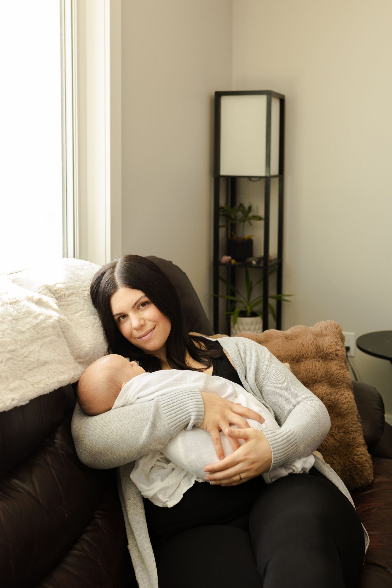Intimate lifestyle photos of a family relaxing together on a brown leather couch.