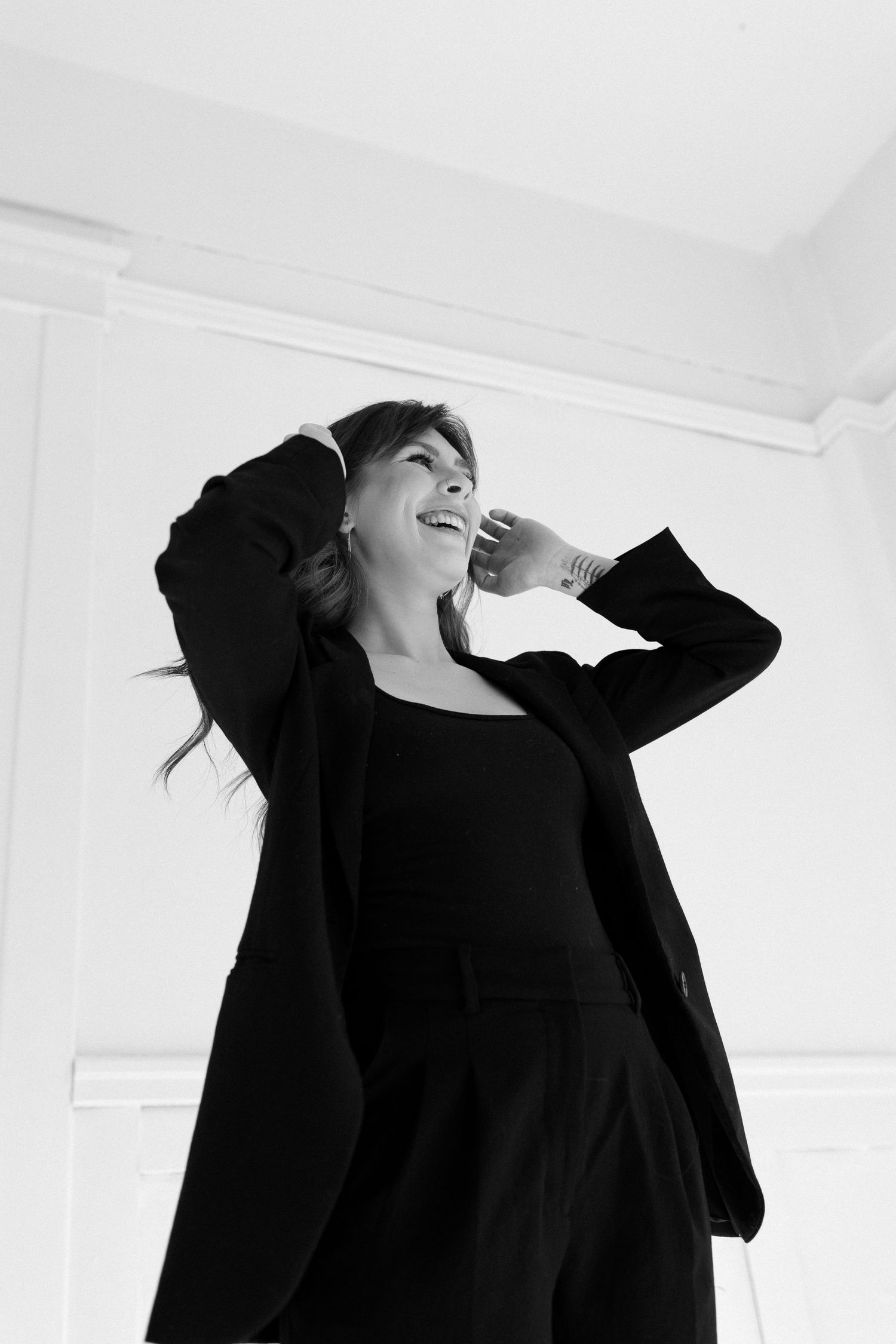 A series of expressive black and white portraits showing joyful laughter against a white background.