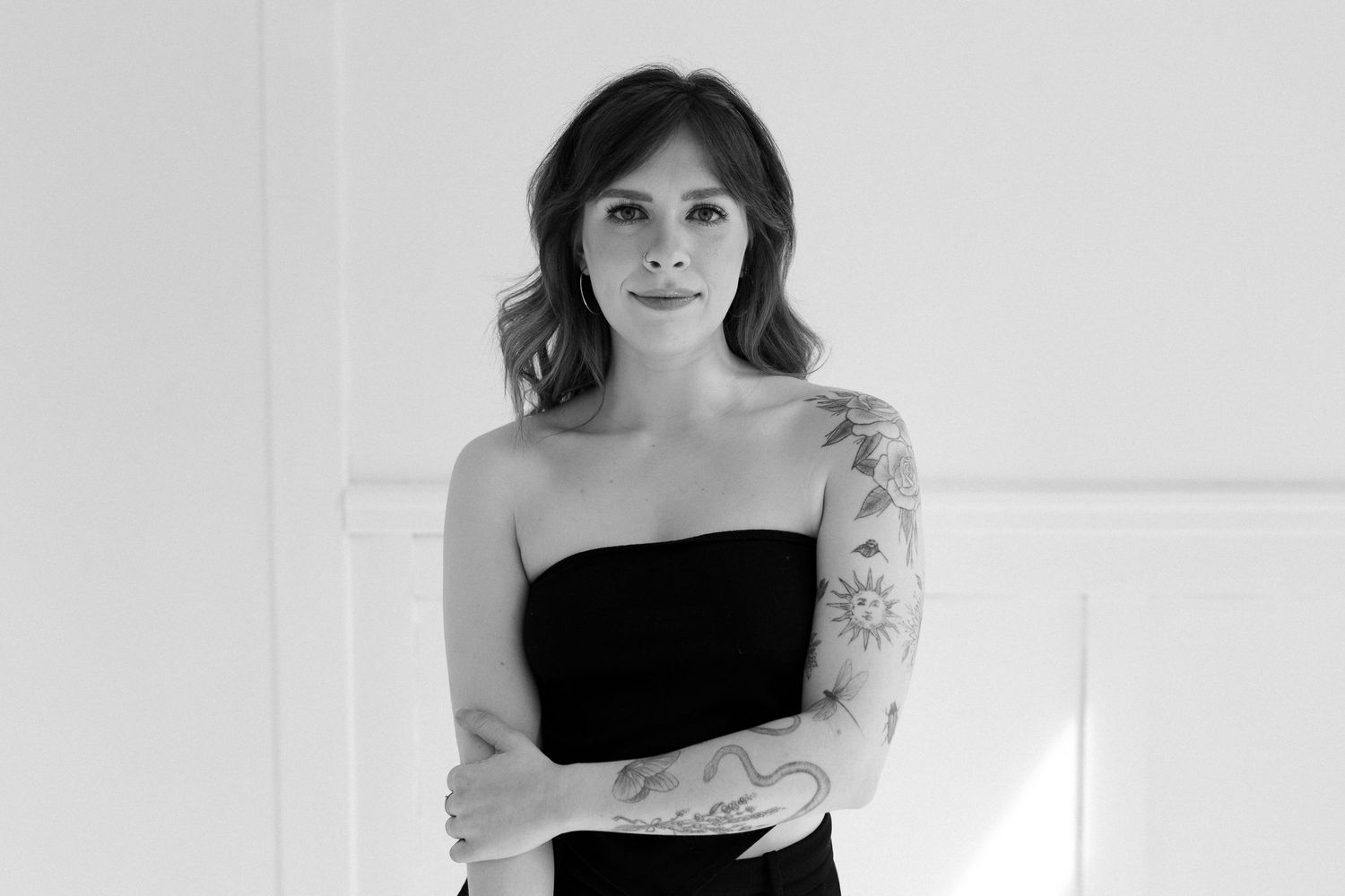 Minimalist portrait series featuring a person in black attire against a white backdrop.