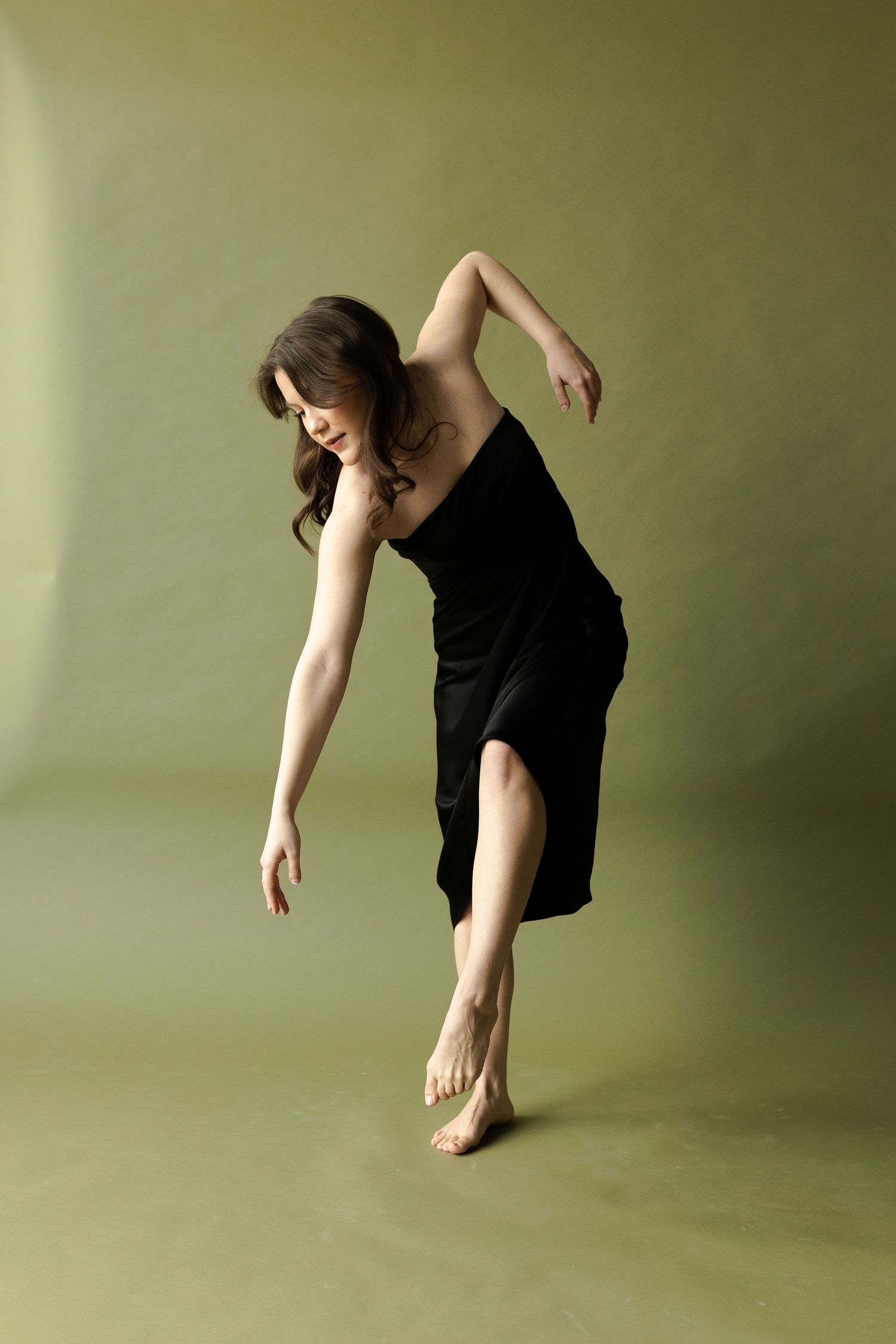 A series of modern dance movements captured in a minimalist setting with olive green backdrop.