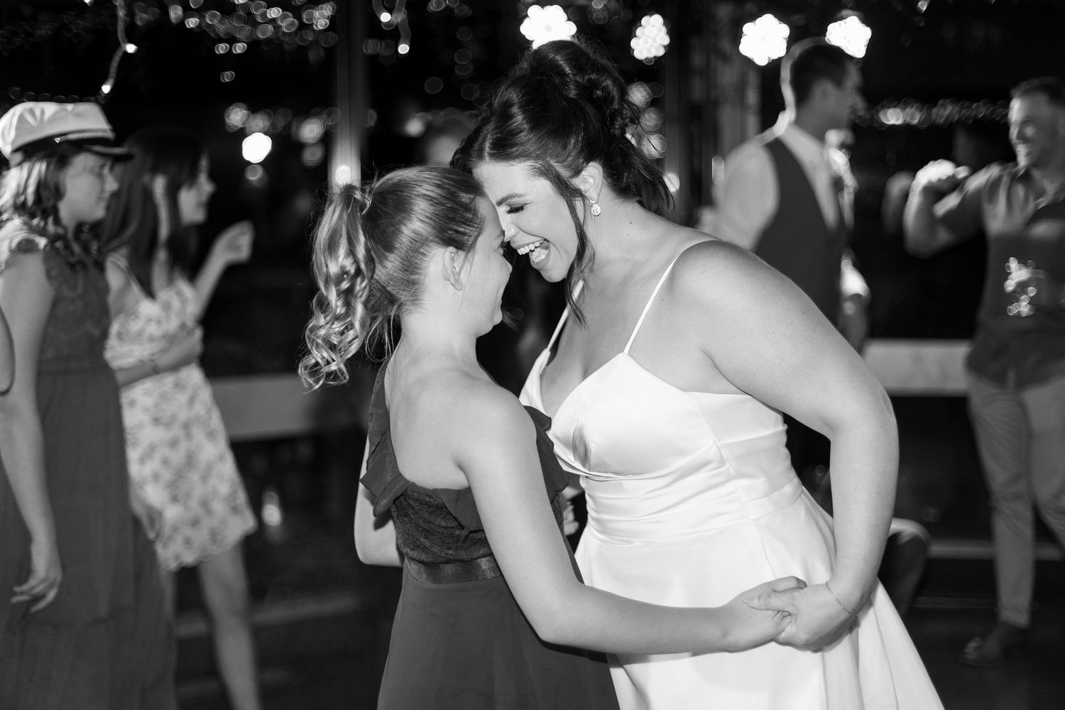 Wedding reception dance floor filled with guests enjoying evening celebration.