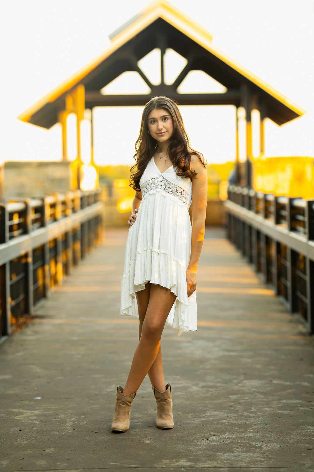 Stylish poses captured on a wooden pier during golden hour.