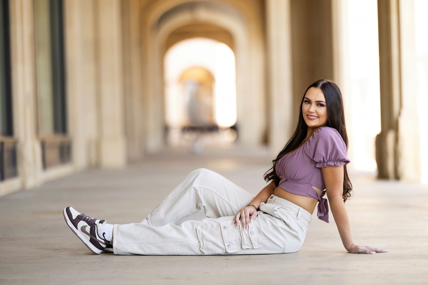 A sequence of artistic fashion photos showing a model in white clothing posing against an elegant arched hallway.
