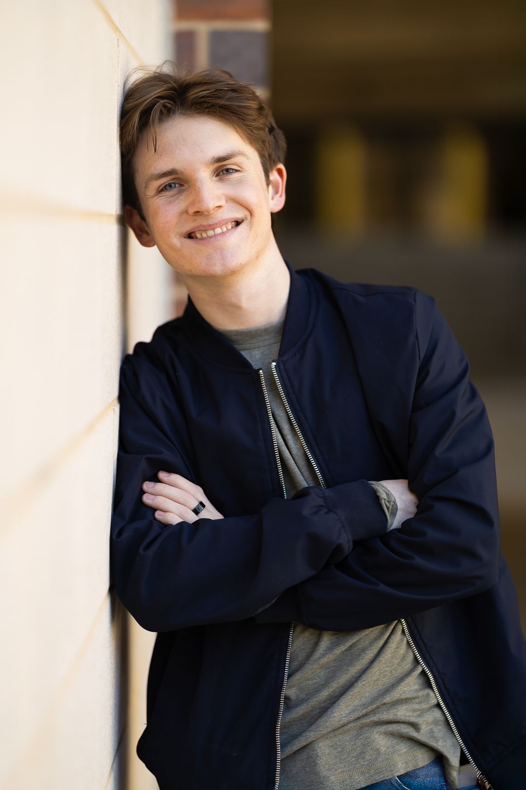 A series of casual portrait photos showing someone in a navy jacket and gray shirt against a blurred background.