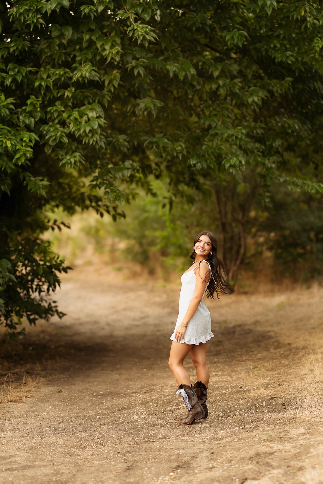 Outdoor natural photoshoot senior session spring time.  What to wear white dress and cowboy boots. Frisco Texas.