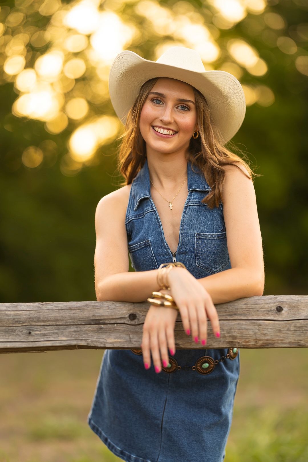 Casual outdoor senior portraits with cowboy hat.  Tall grassy setting.  Frisco Texas