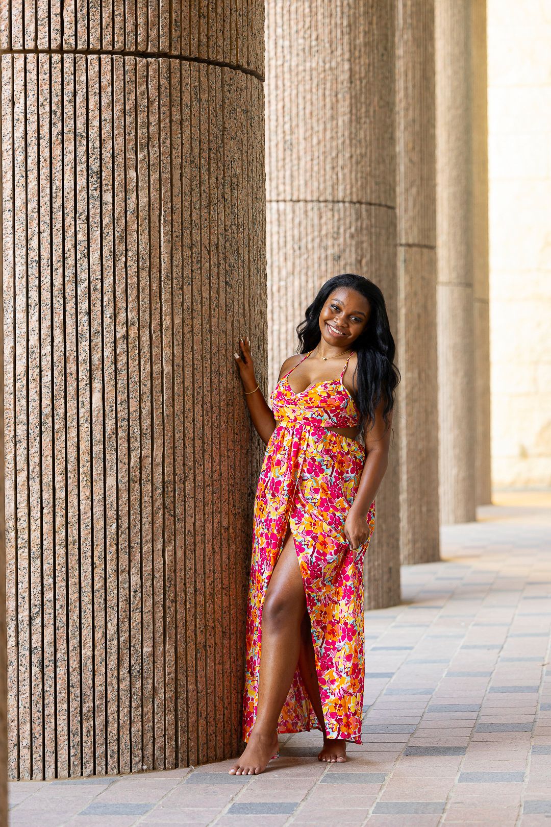 Vibrant floral dress portrait session with classic architectural columns.