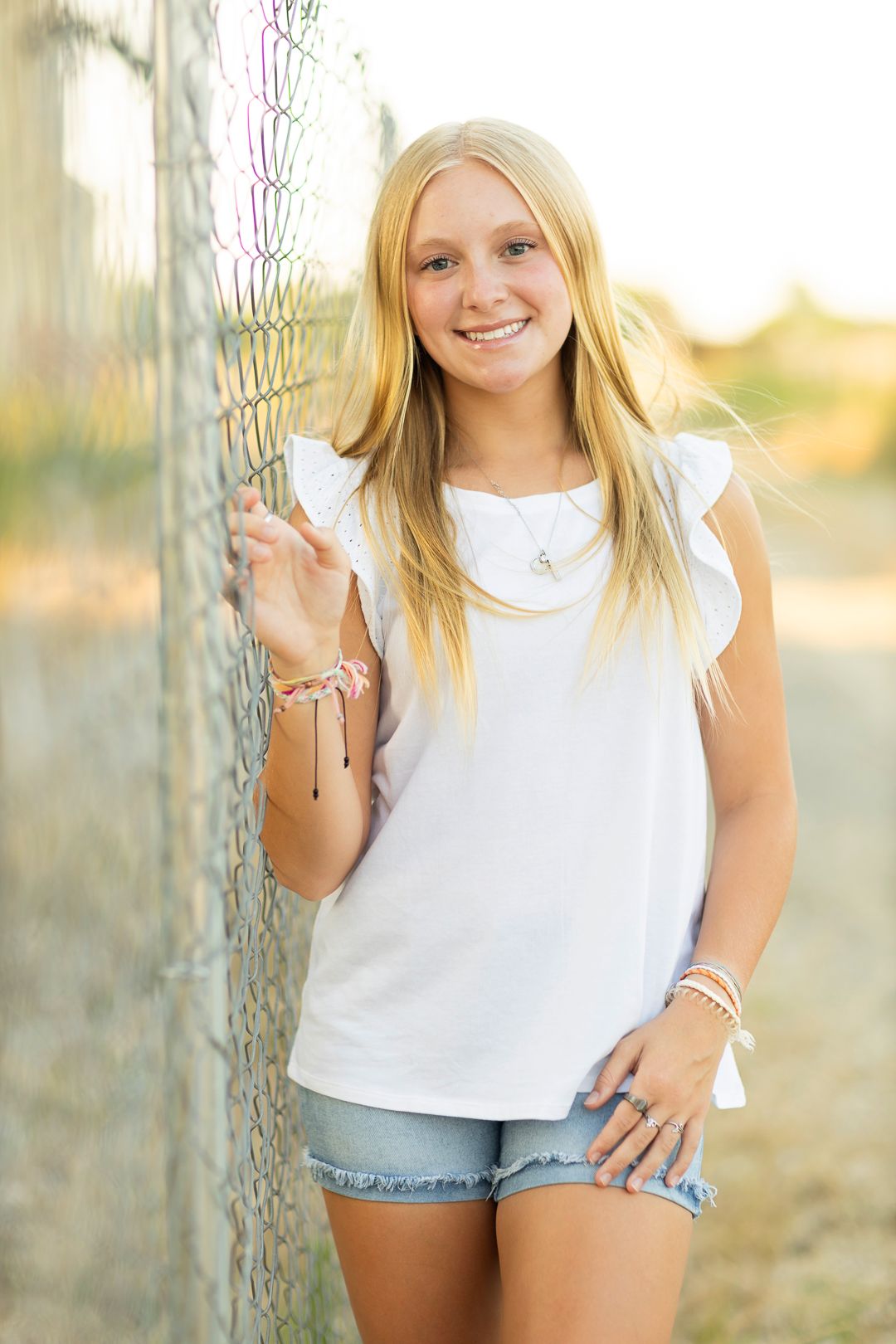 Outdoor lifestyle photos featuring white top and denim shorts against a natural background.