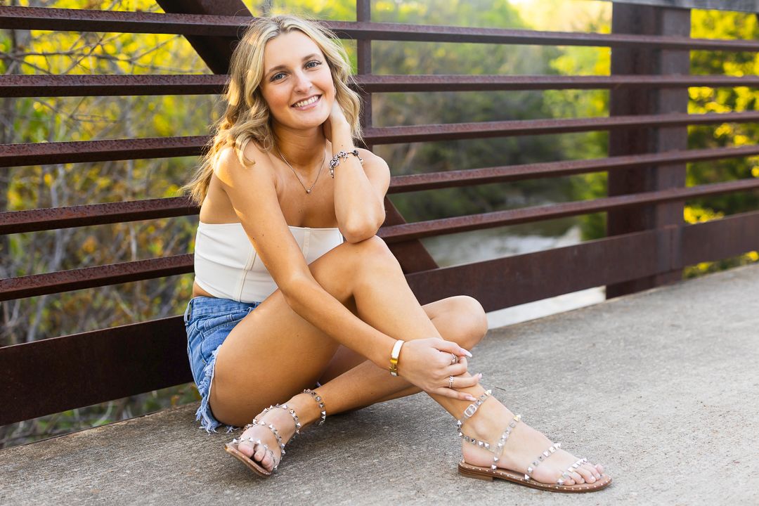 Casual outdoor photos on wooden bridge showing summer sandals and denim details.
