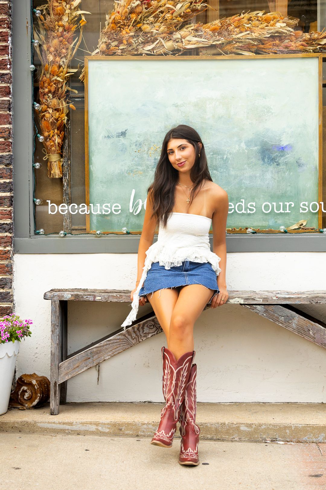 Fashion series with cowboy boots and denim outside a storefront window.