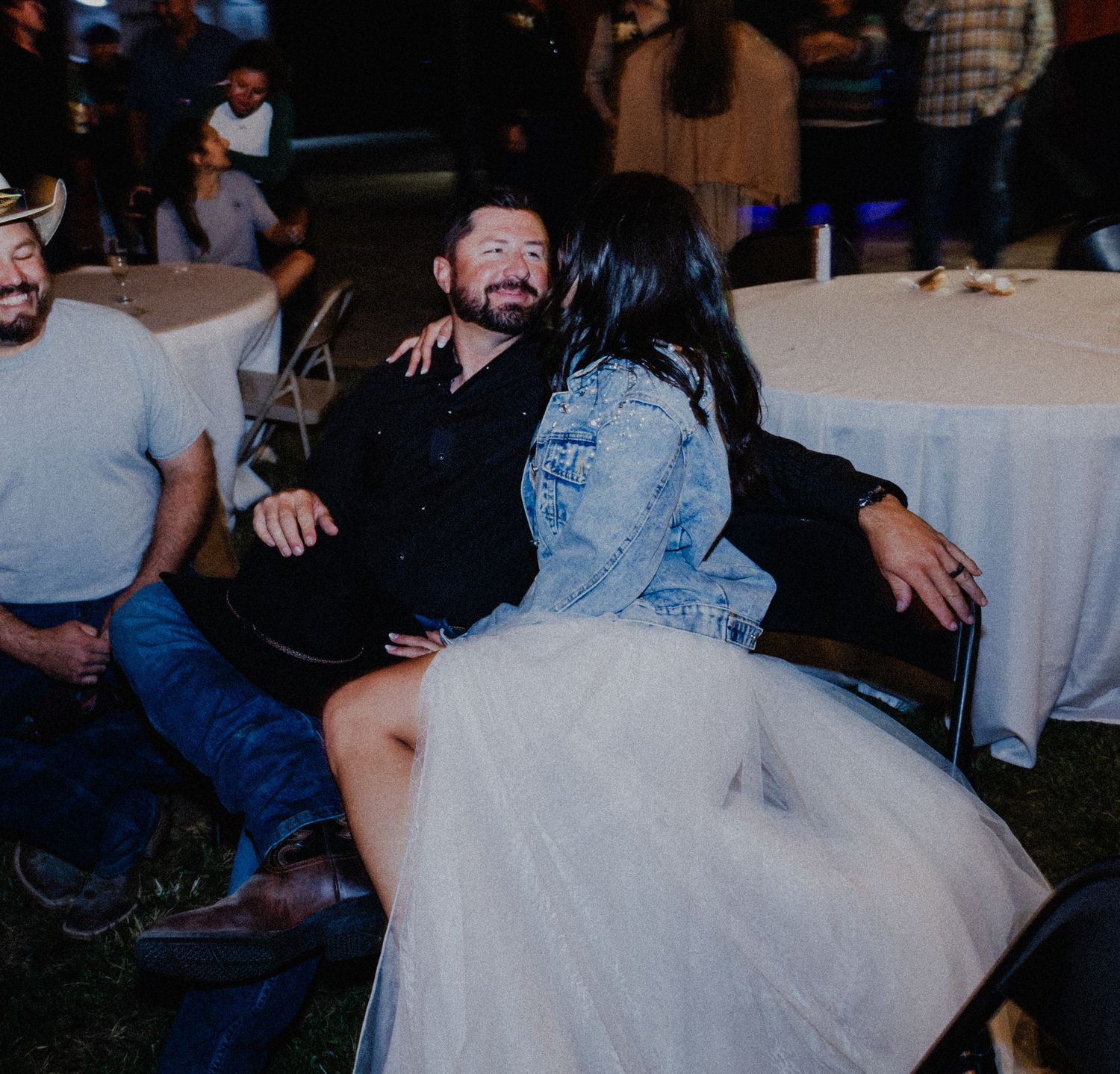Dancing in joy at a wedding reception as onlookers form a circle during an energetic moment on the dance floor.