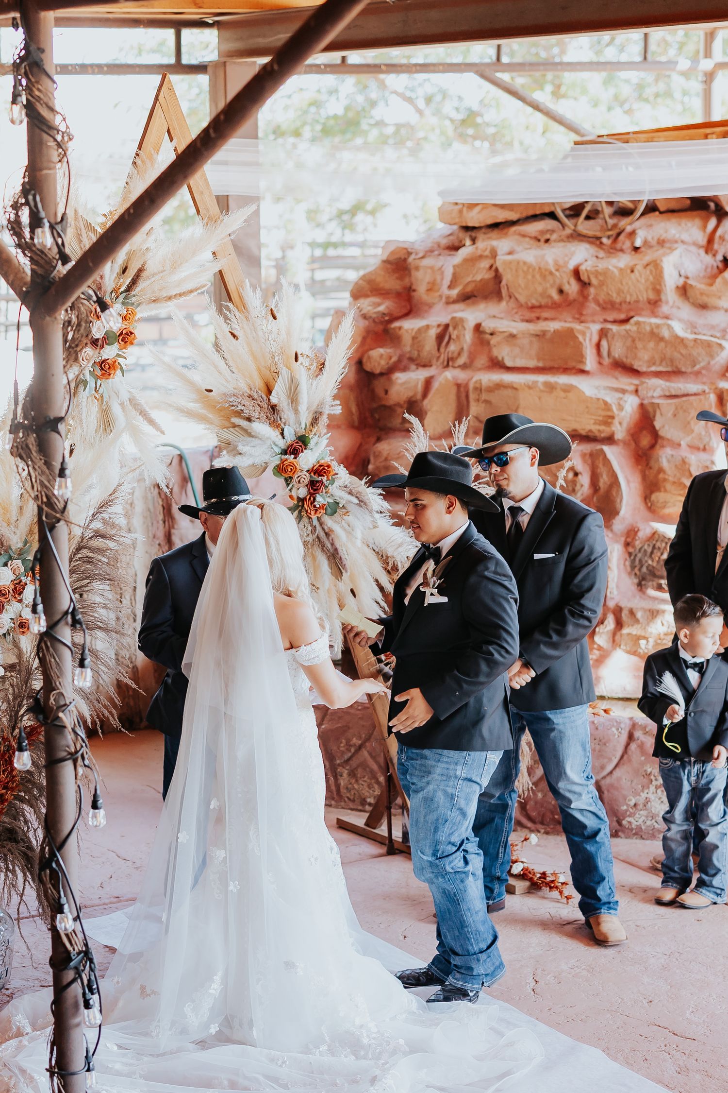 Three sequential photos capture a sweet first look moment between a bride and groom at a rustic stone venue.