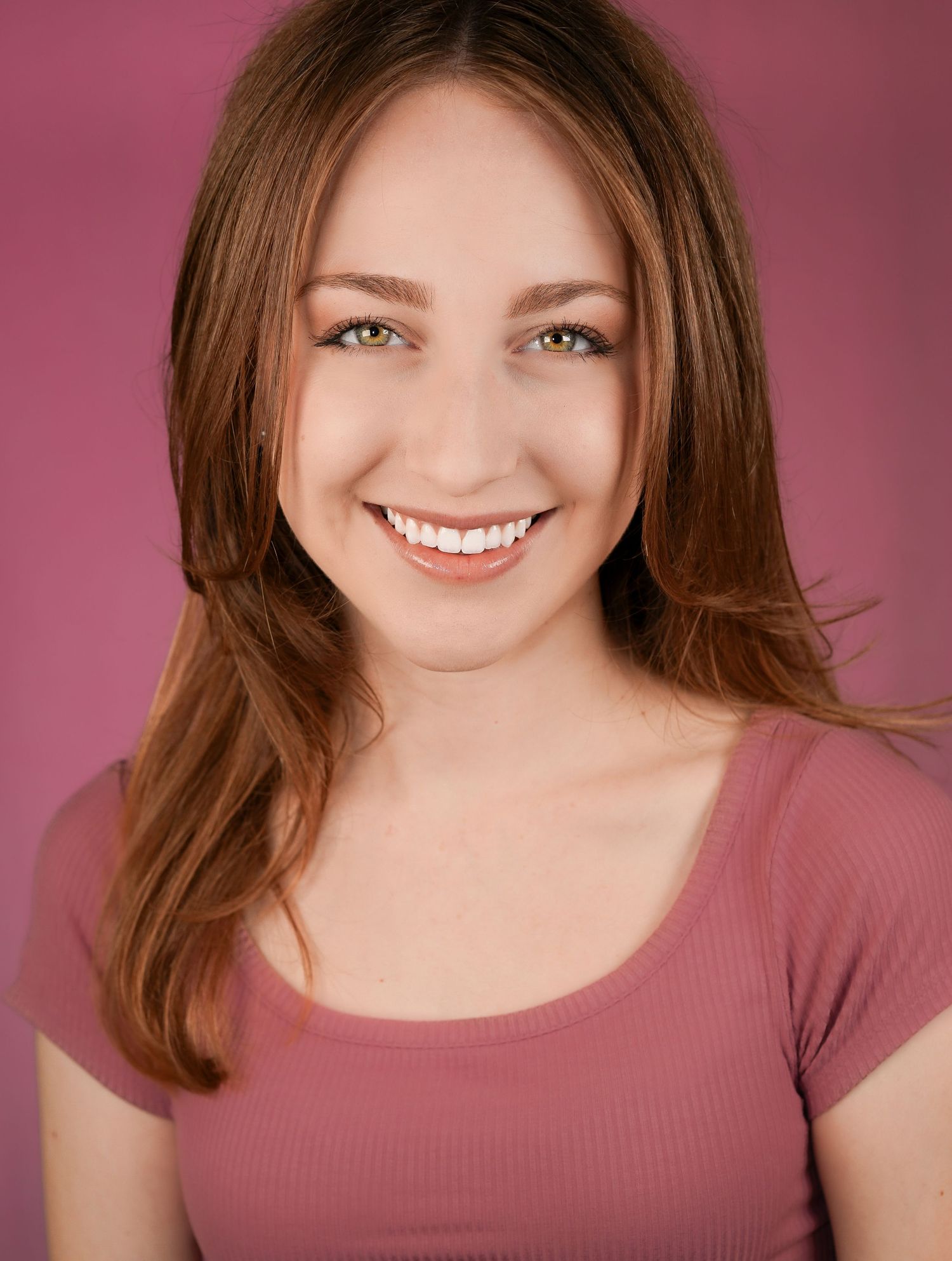 A studio portrait series of someone in a mauve top against a pink background showing different expressions and poses.