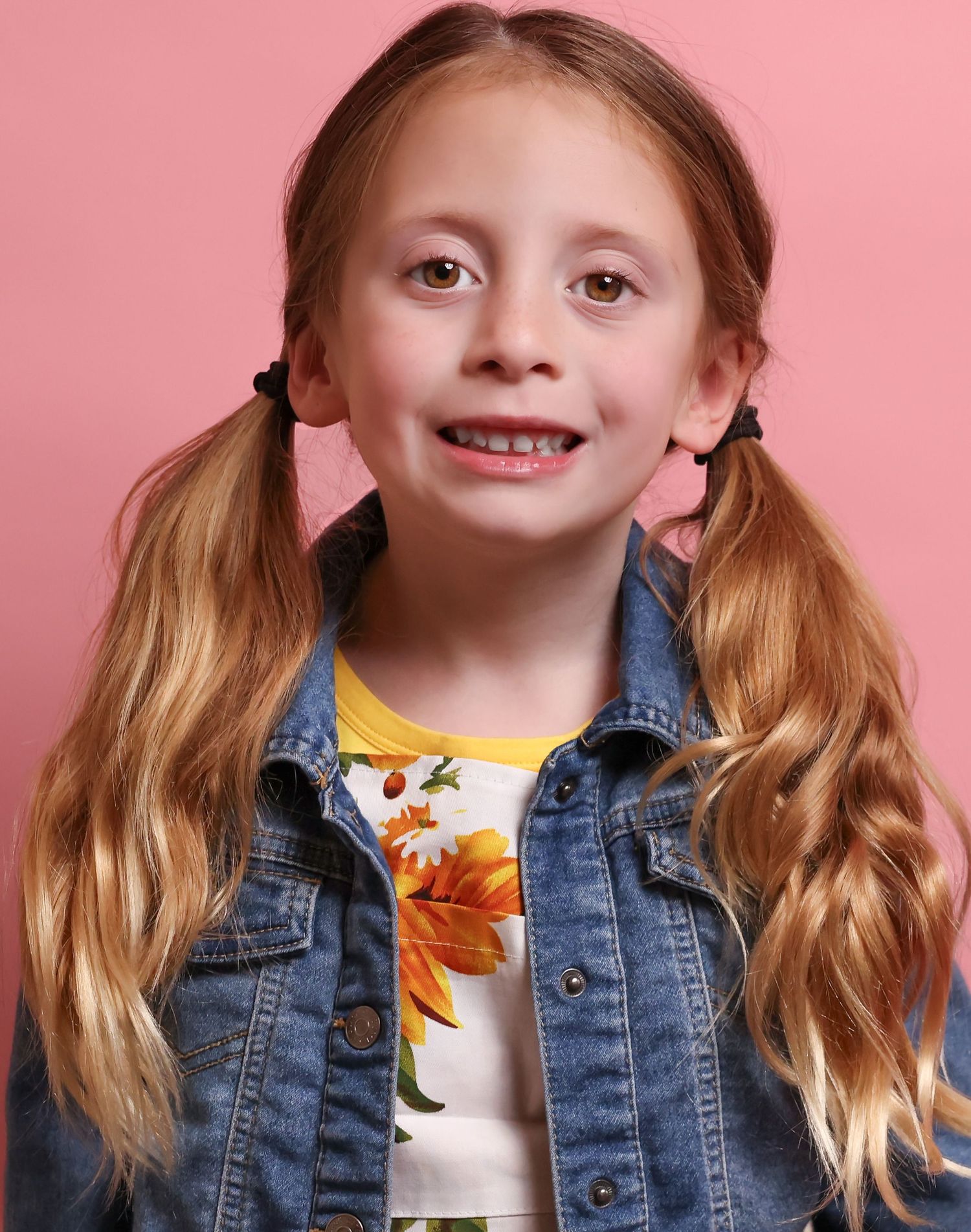 Child model poses in denim jacket against pink background with various expressions.
