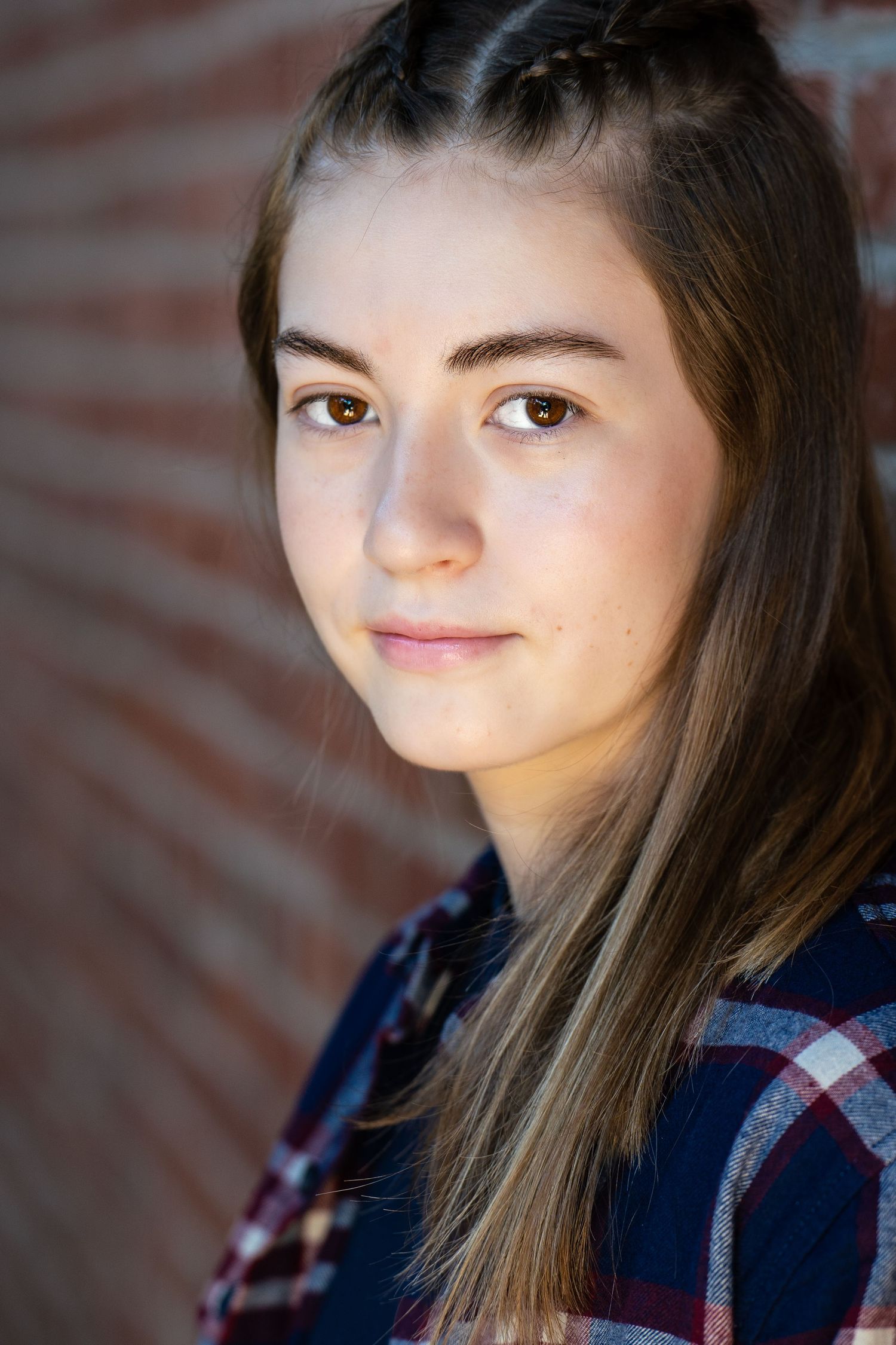 Multiple profile views showing different angles of a person with long brown hair wearing a navy and red plaid shirt.