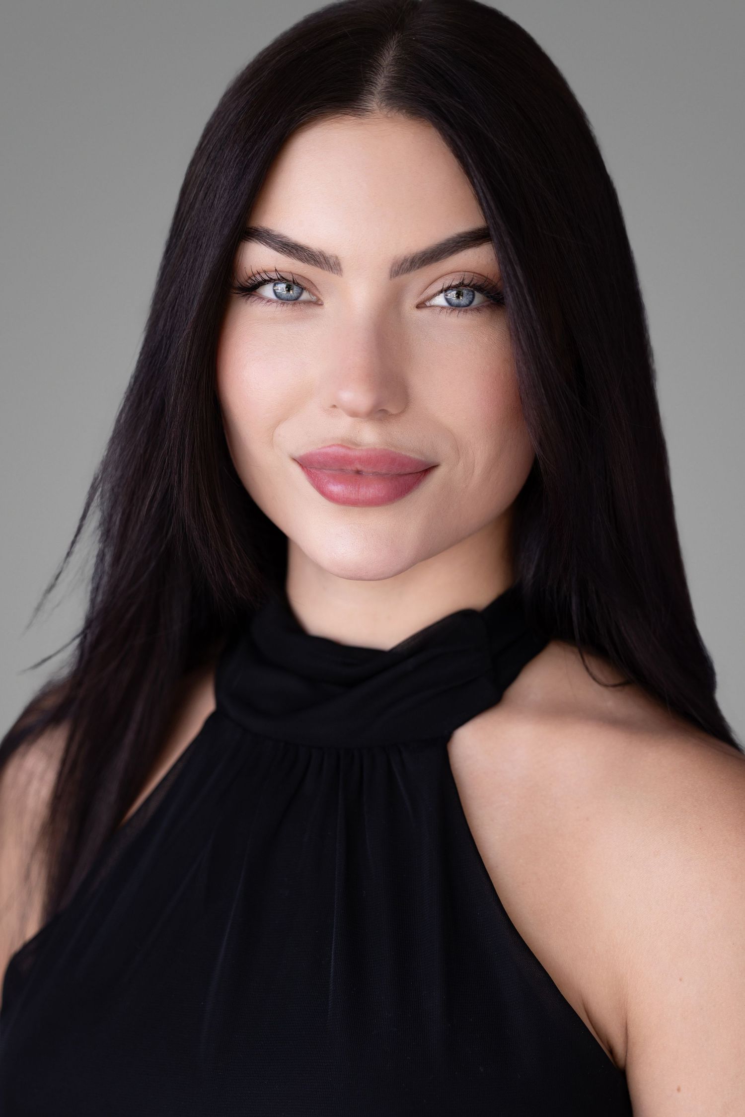 Elegant headshot series in black halter top against grey background.