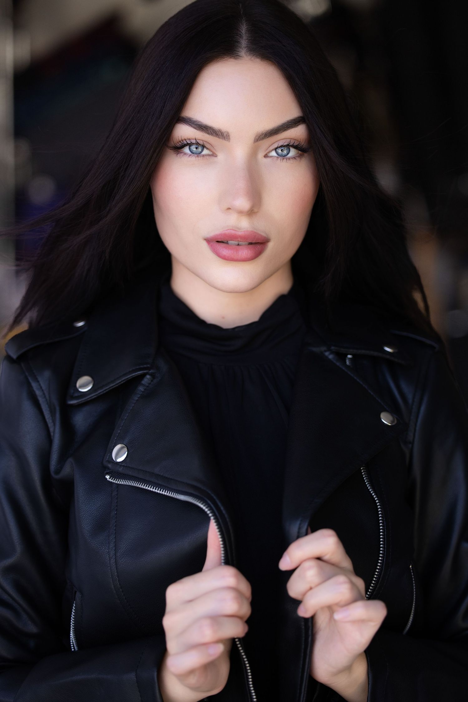 Series of poses in a black leather jacket with dramatic lighting and dark background.