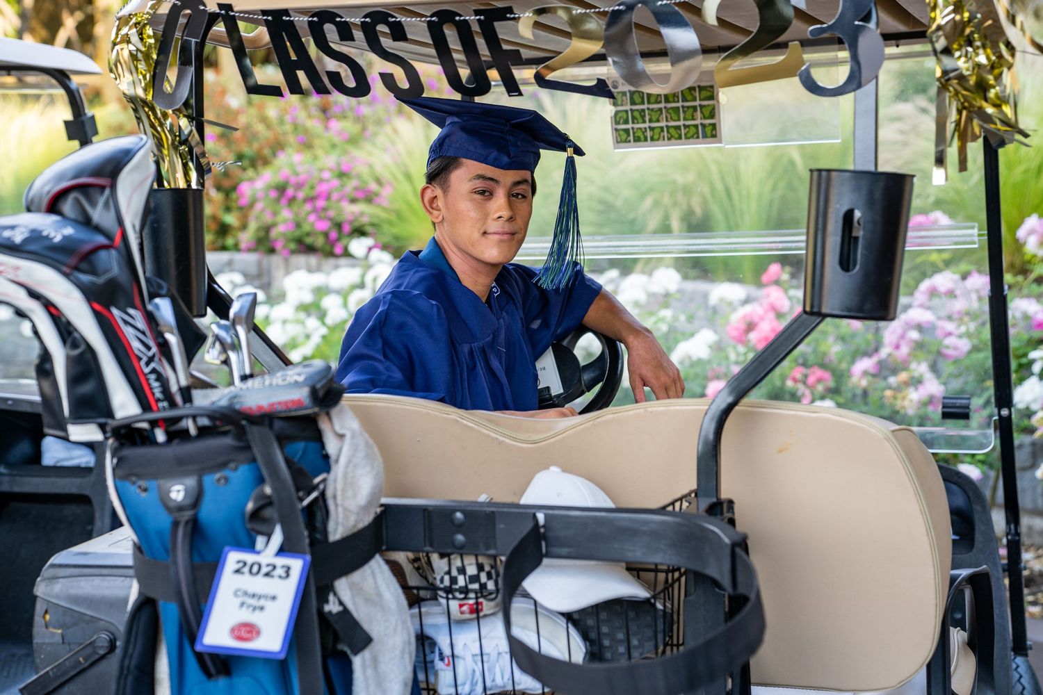 Golf carts lined up at a golf course event with Class Of signage visible.
