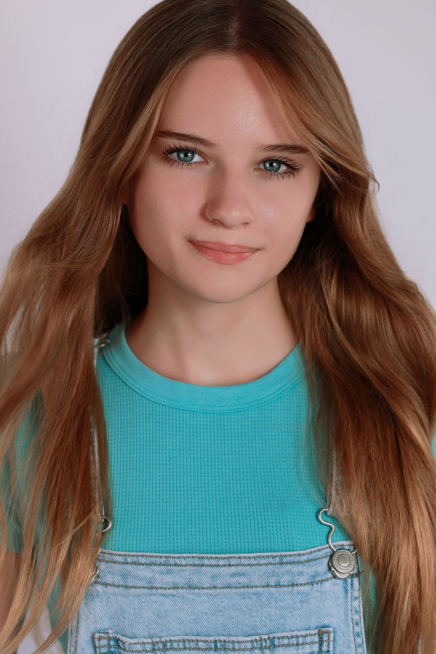 Four identical portraits of someone with long brown hair wearing a turquoise top and denim overalls.