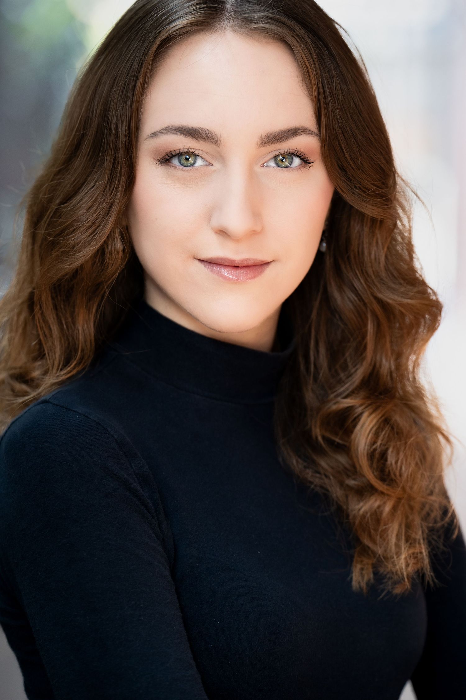 Headshot series showing a person with long wavy brown hair wearing a black turtleneck against a light background.