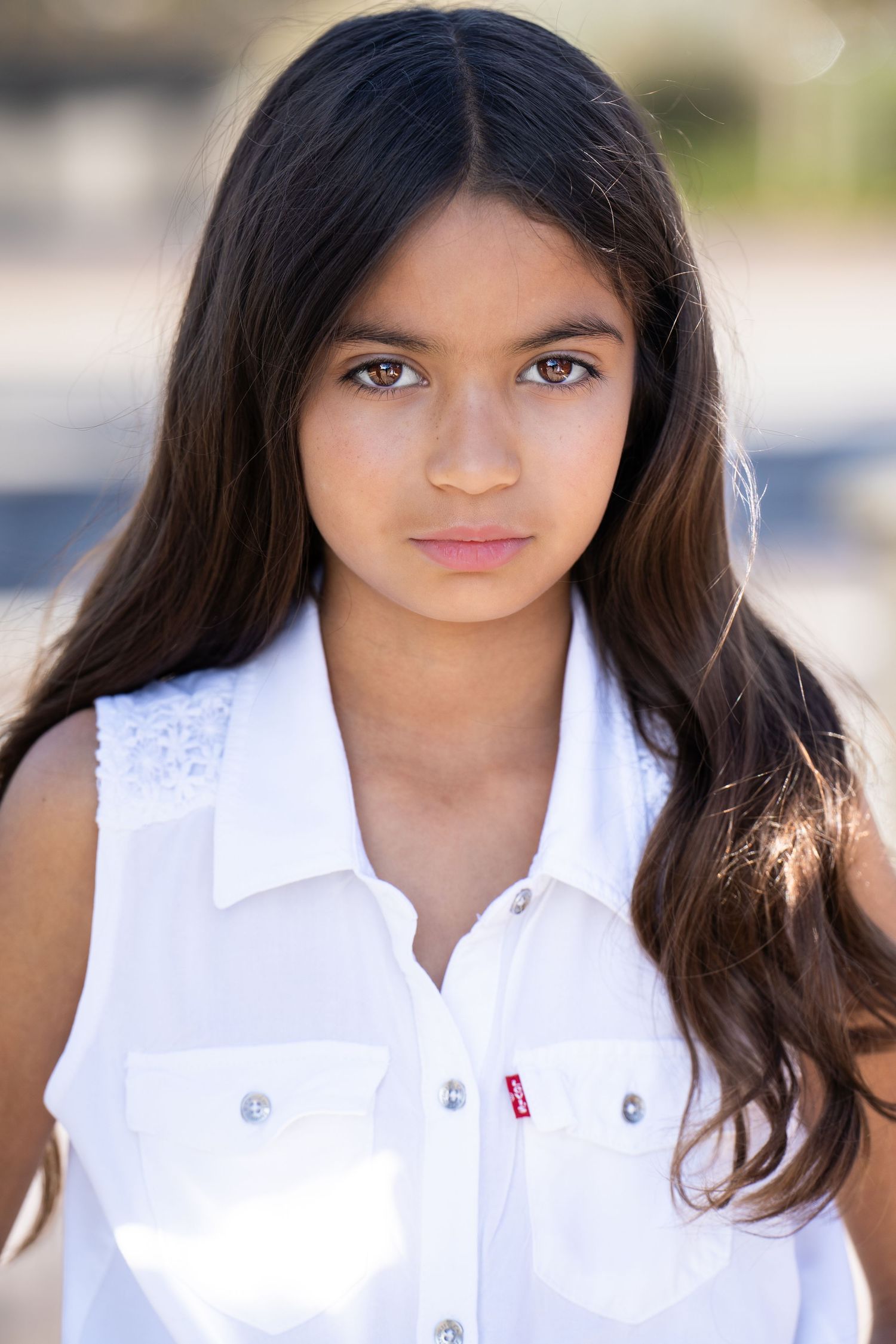 Headshots of model wearing crisp white collared shirt outdoors.