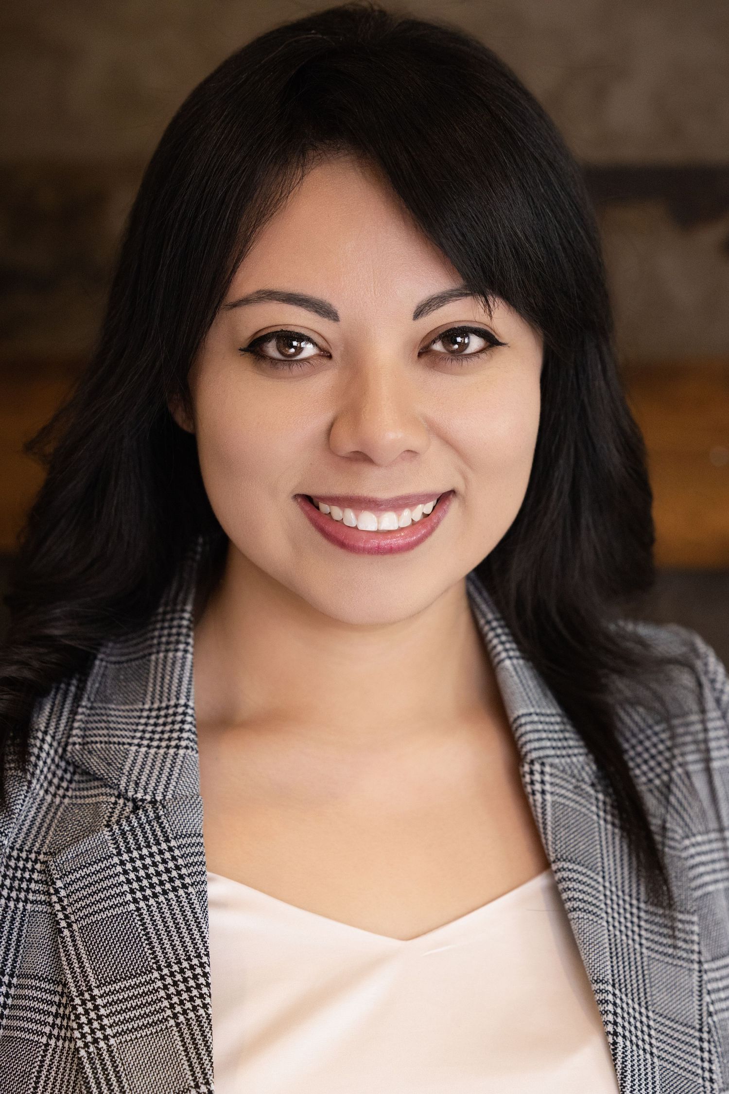 A close-up photo series showing bright smiles and expressions in a professional headshot style against a dark background.