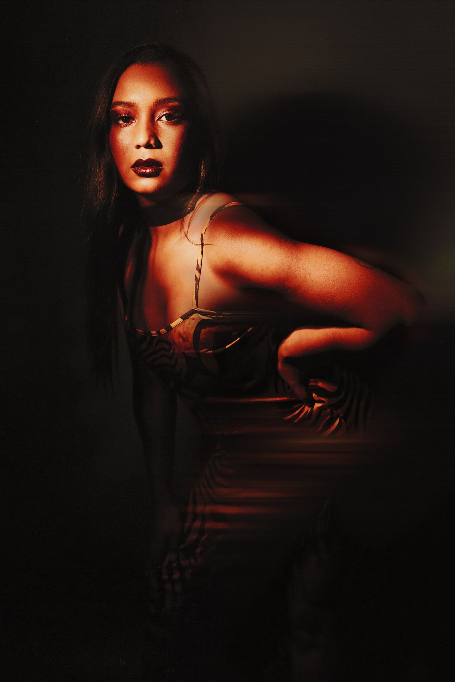 Dramatic portrait sequence with moody red lighting creating an artistic silhouette effect against dark background.