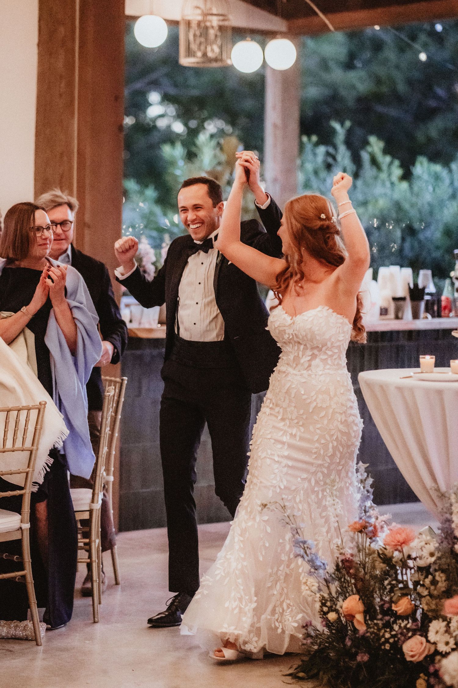 Bride and groom share joyful first dance at elegant wedding reception.