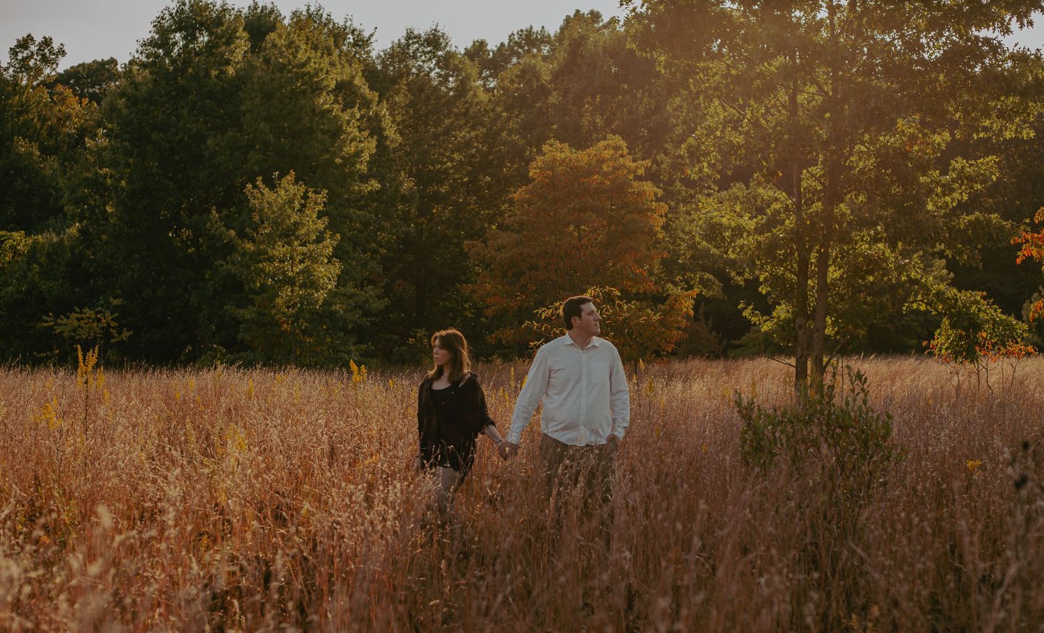 A romantic photoshoot in a golden field during fall season.