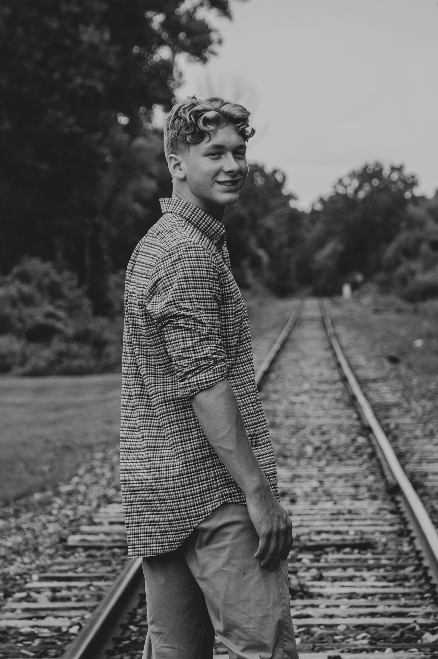 Black and white photo of railroad tracks stretching into the distance.