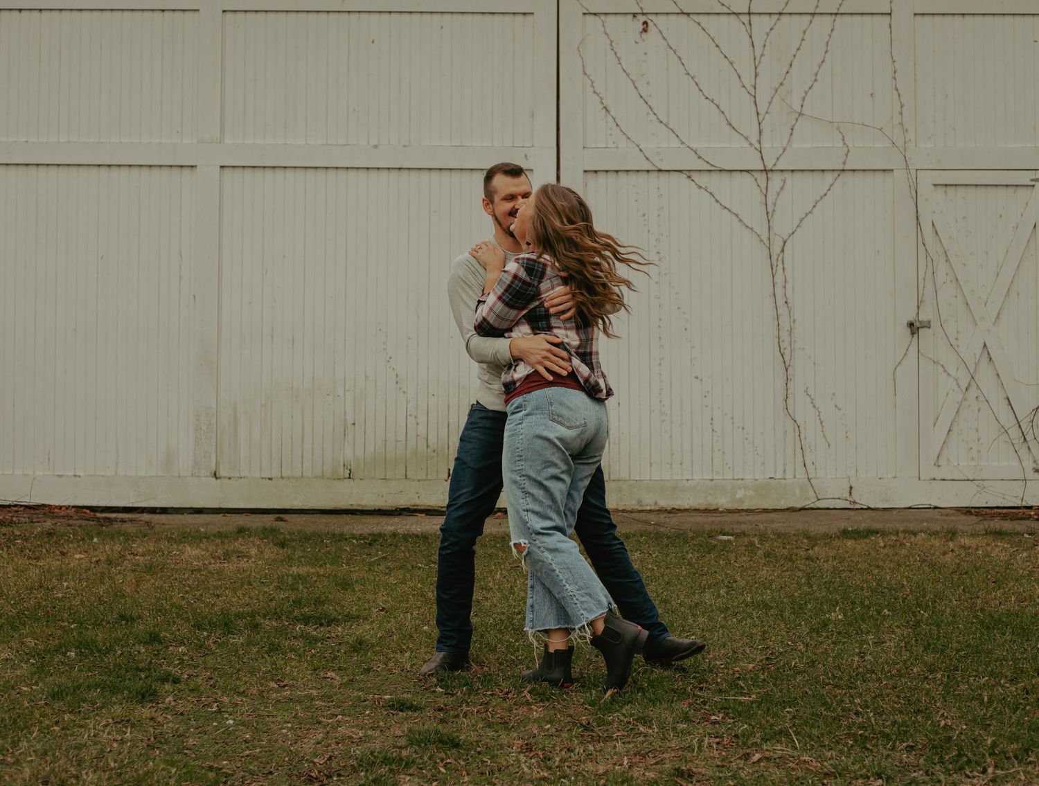 Candid moments captured in a backyard setting with white paneled walls.