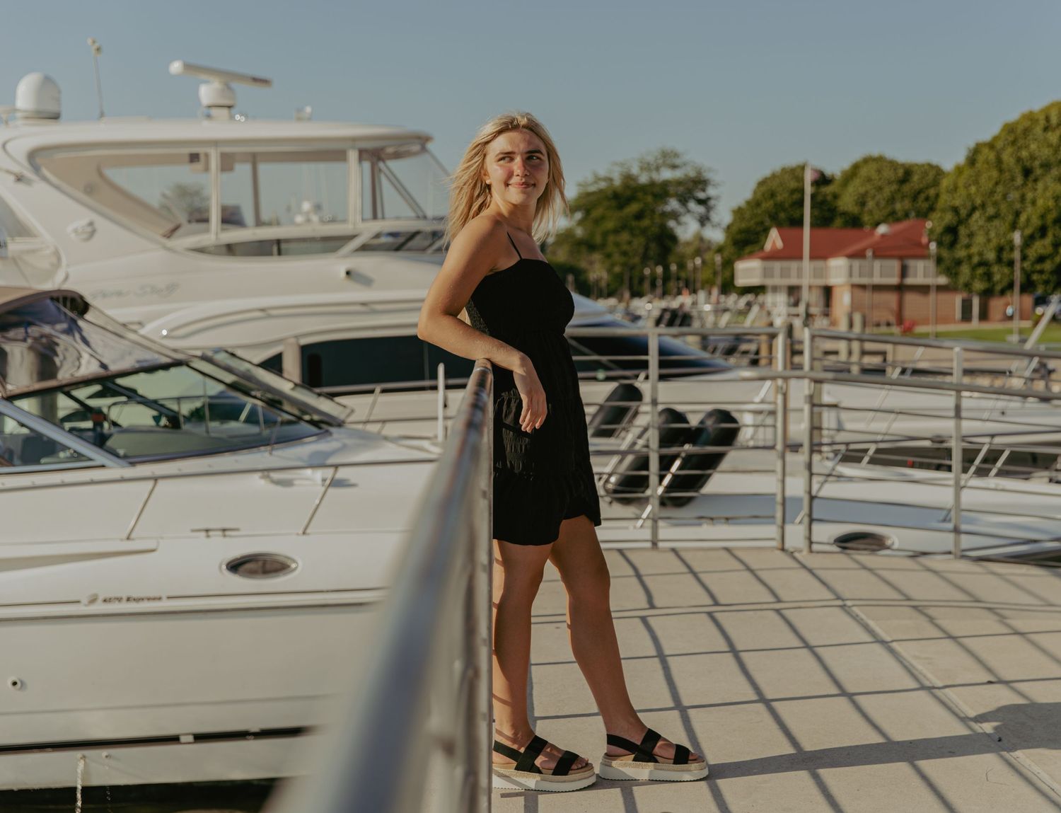 Boats docked at a marina on a sunny day.