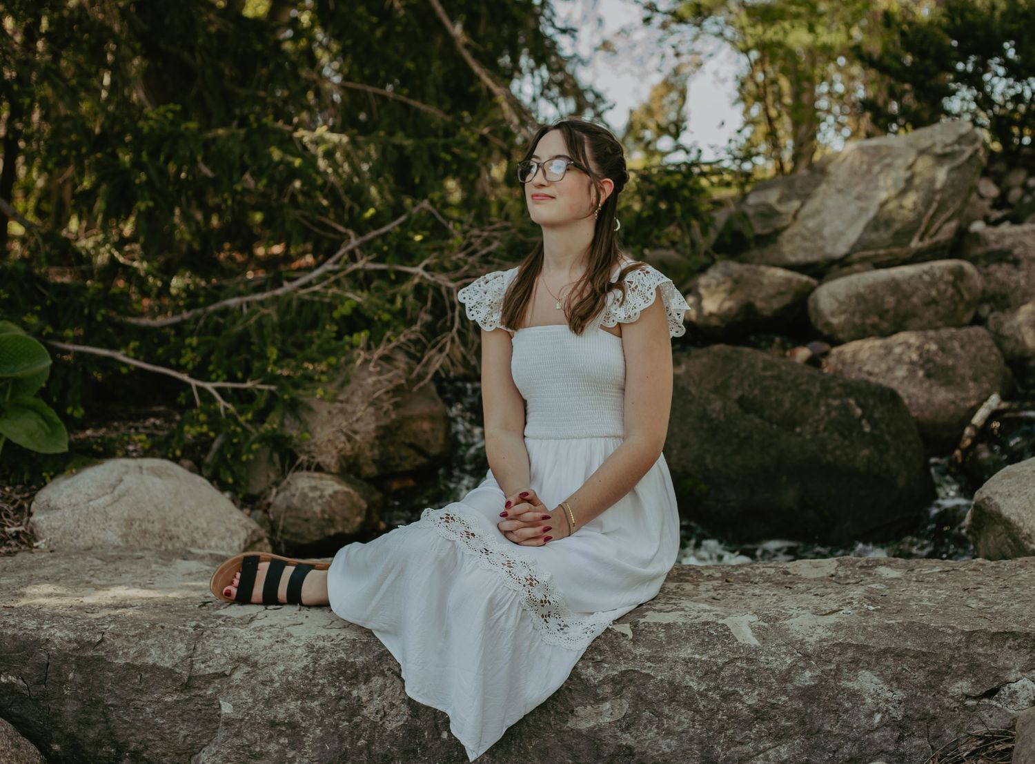 A white dress against a natural rock backdrop in nature.